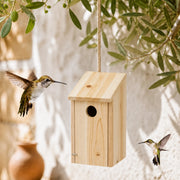 Birdhouse hanging in fir